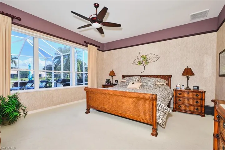 Carpeted bedroom featuring baseboards and a ceiling fan