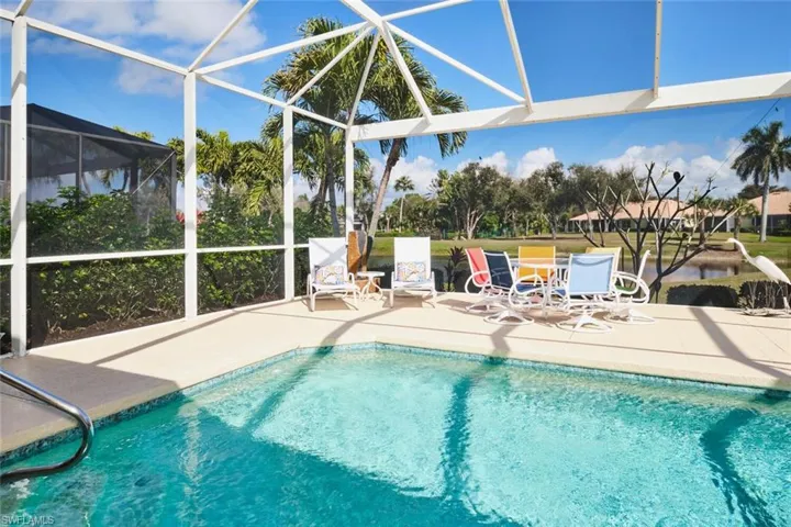 Swimming pool with a lanai, a patio, and a sunroom