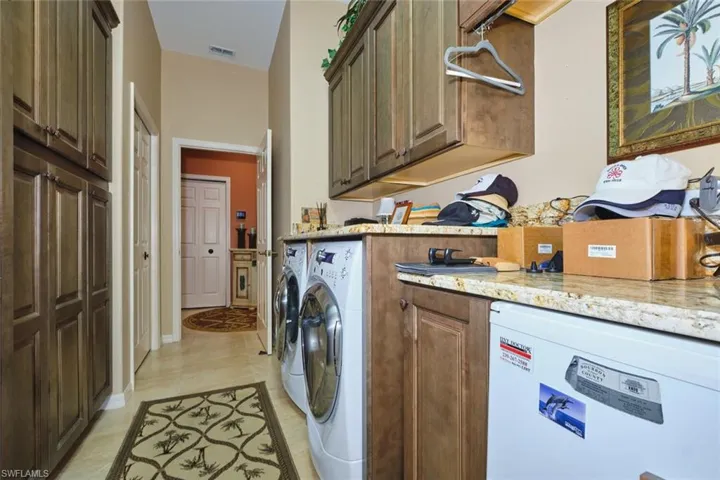 Laundry area featuring cabinet space and washing machine and clothes dryer