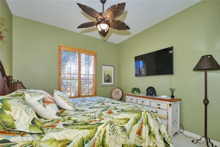 Bedroom featuring a ceiling fan and baseboards