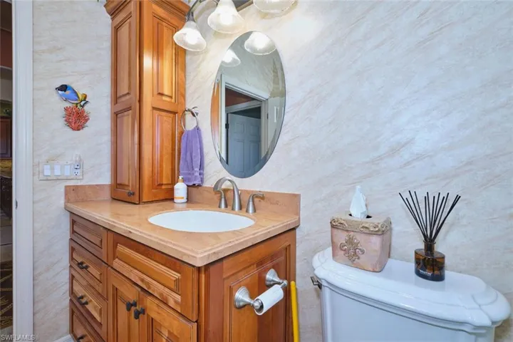 Bathroom featuring vanity and wallpapered walls