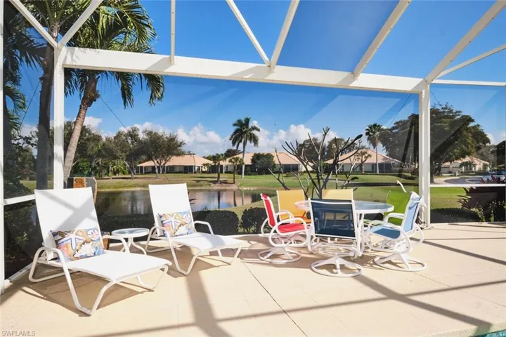 View of patio featuring a water view, a sunroom, a lanai, and a residential view