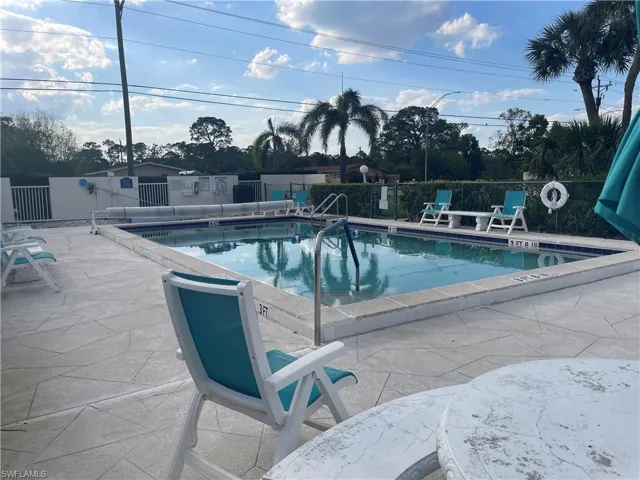 Pool featuring a patio area and fence