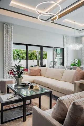 Living area with a chandelier and a tray ceiling
