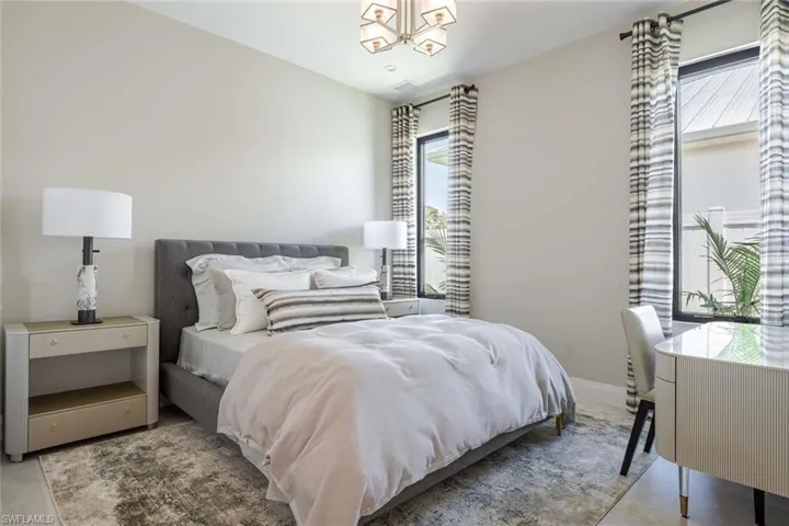 Bedroom featuring a chandelier and baseboards