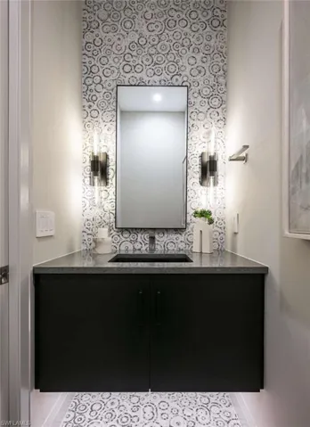 Bathroom featuring vanity and wallpapered walls