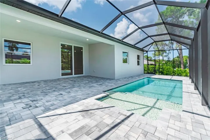 View of swimming pool featuring a lanai and a patio area