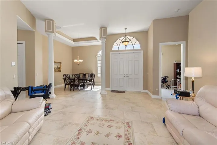 This view of the living area you can see the dining area just off to the left with beatutiful columns.