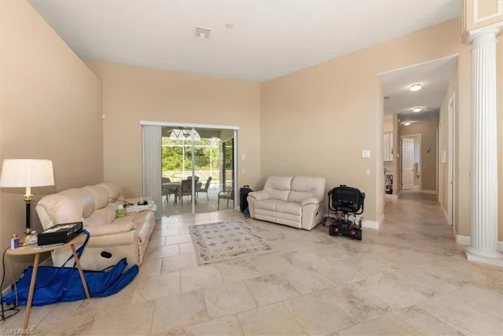 View from the entry and a glimpse of the pool area. 18 inch tile throughout laid in a brick pattern throughout.