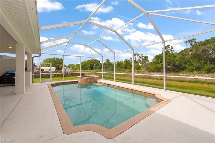A very large pool area with a waterfall that flows from the hot tub. Lots of room to catch some sun as well as a large under truss area to relax as well.