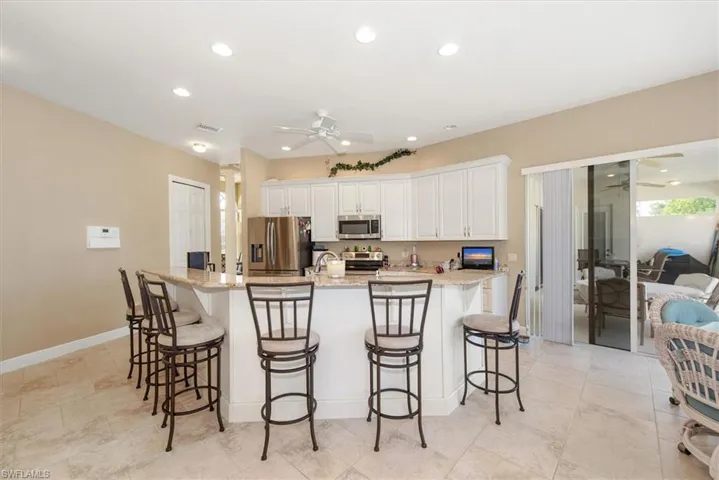 The kitchen features a raised bar area with plenty of room for 6 to eat around. There is also a eat in kitchen area to the right with closer pool views.