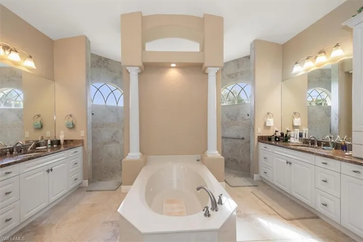 This is a very spacious bathroom with a large soaking tub and a walk through shower. Lots of storage space in the oversized vanities.