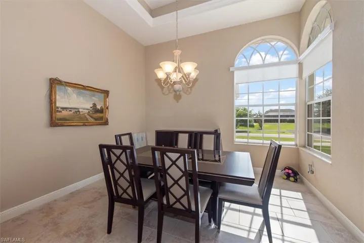 The dining room area 12'10" x 12'10" with a tray ceiling of 12'