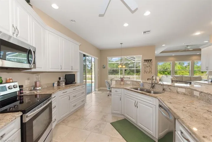 Another view of the kitchen which features granite counter tops