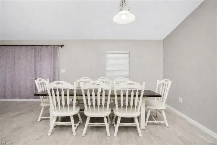 Dining room featuring light wood-style flooring and baseboards