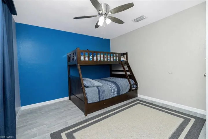 Bedroom featuring light wood-type flooring and ceiling fan