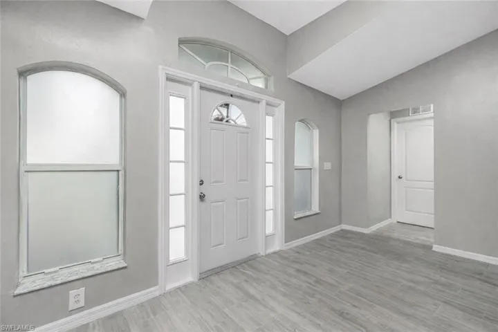 Entrance foyer featuring baseboards and light wood-type flooring