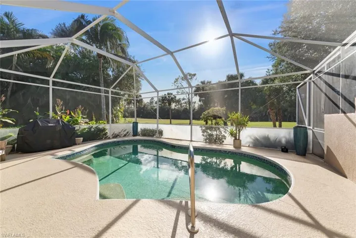 Outdoor pool featuring a lanai, grilling area, a sunroom, and a patio area