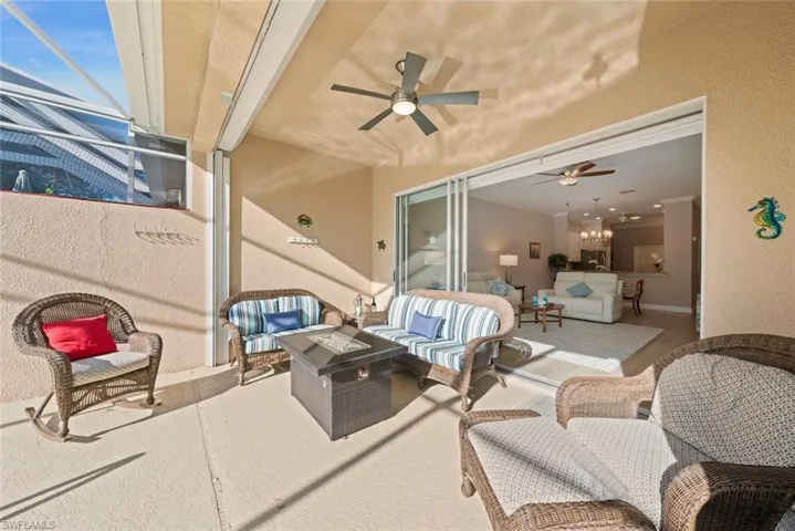 View of patio featuring an outdoor living space with a fire pit, and ceiling fan