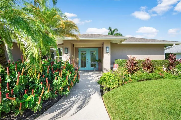 Property entrance featuring a yard and french doors