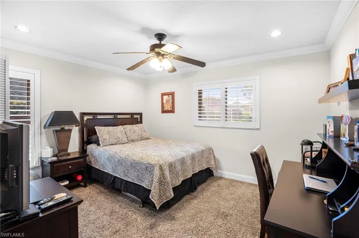 The bedroom is spacious with a walk-in closet and offers extensive adjustable natural lighting from large windows with Bahama shades.