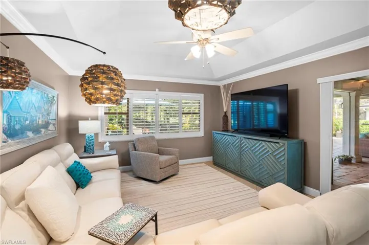The family room along with the kitchen create a large gathering area for friends and family. The family room provides easy access to the fabulous pool/lanai area through the sliding glass doors.