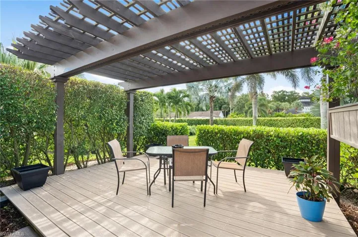 Side deck with pergola surrounded by lush landscaping for a more private retreat.