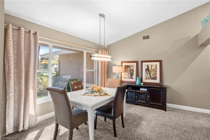 A formal dining room viewing lush landscaping is one of several dining areas offered in the home.