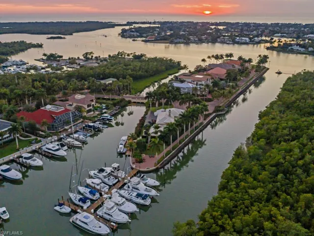 Aerial view of property and surrounding area with a nearby body of water