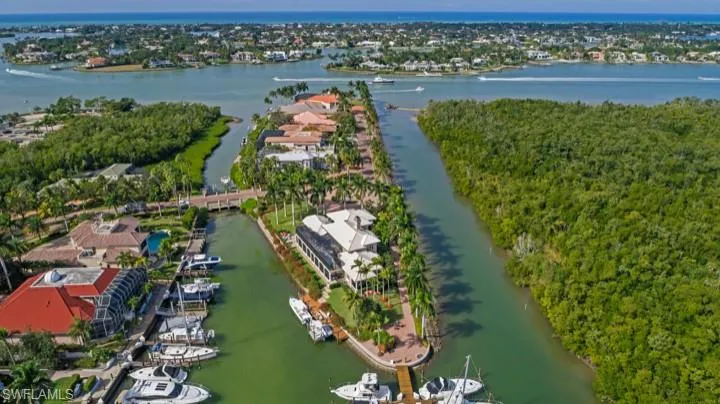 Aerial perspective of suburban area featuring a nearby body of water