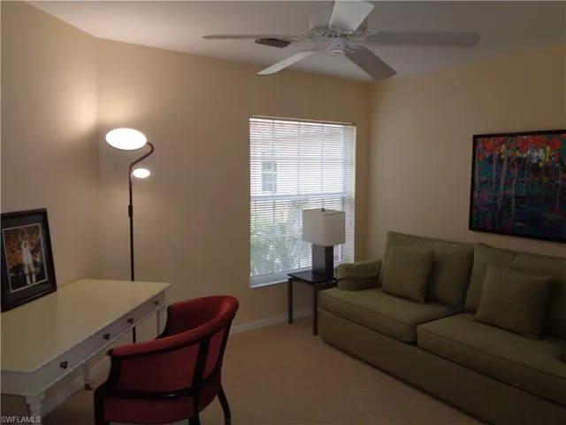 Carpeted office space with baseboards