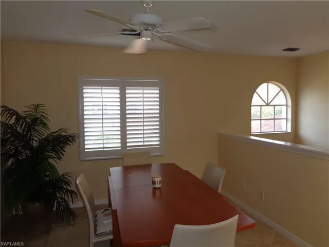 Dining room with tile patterned flooring and a ceiling fan
