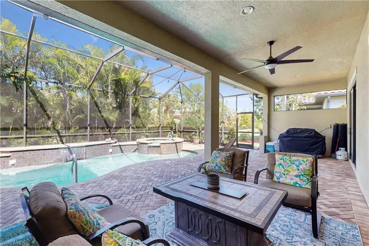POOL & SPA WITH VIEW OF WATERFALL, ENCLOSED LANAI & POOL AREA