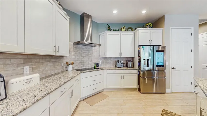OVERSIZE KITCHEN, COUNTER  TOPS, LIGHT COLOR CABINETS, STAINLESS STELL APPLIANCES, OVEN/MICROWAVE.