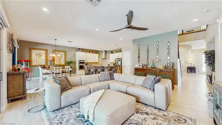 ALL TILE FLOORING, HUGE FAN, HUGE SECTIONAL, NOOK AREA FOR EATING, BREAKFAST BAR, LIGHT COLOR KITCHEN CABINETS