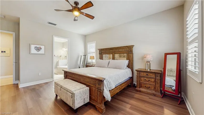 OVERSIZE MASTER BEDROOM W KING SIZE BED, NATURAL LIGHT FROM WINDOWS, LAMINATE FLOORING, FAN LIGHT, ENTRANCE TO MASTER BATH OR DOOR TO FAMILY ROOM