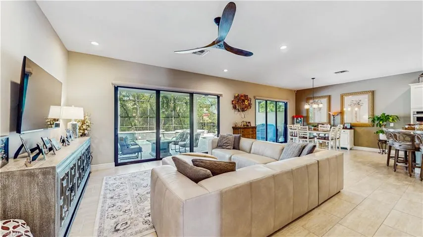 FAMILY ROOM, ALL TILE, MOUNTED WALL TV, NOOK AREA W-TABLE & 8 CHAIRS, BREAKFAST BAR W GRANITE COUNTER TOPS, 2 SETS OF SLIDING DOOR LEADING ON TO ENCLOSED LANAI, POOL & SPA