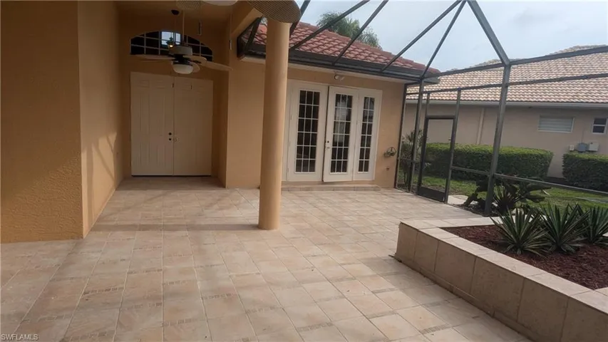 View of patio / terrace with glass enclosure, ceiling fan, and french doors