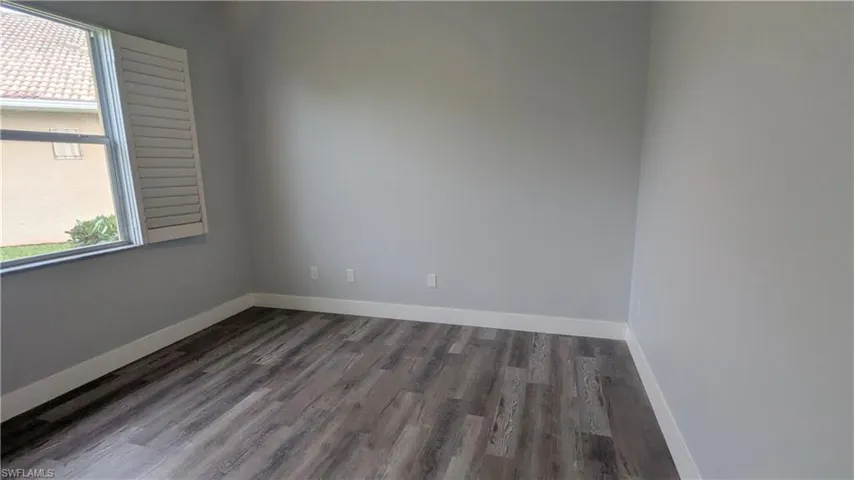 Empty room featuring wood-type flooring