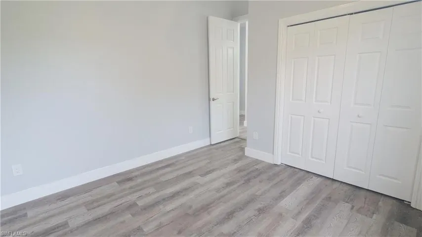 Unfurnished bedroom featuring light hardwood / wood-style flooring and a closet