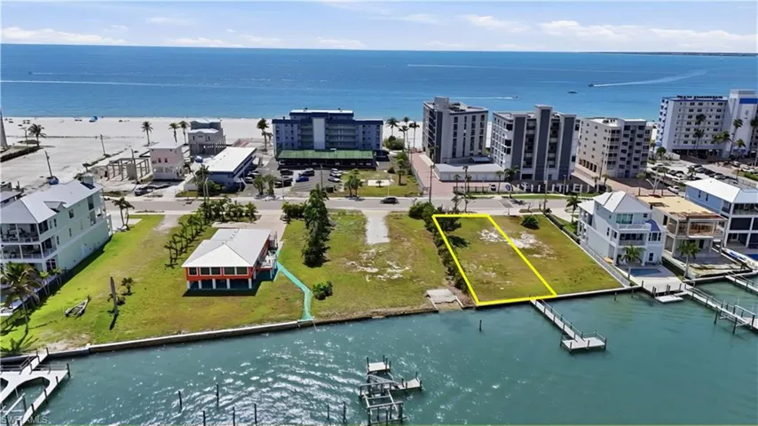 Aerial view of property's location featuring a large body of water and property parcel outlined - Virtually Edited Image