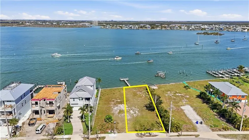 Aerial view of residential area with property boundaries highlighted - Virtually Edited Image