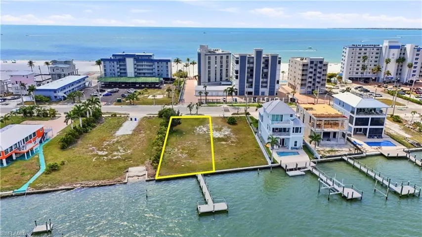 Aerial overview of property's location with a nearby body of water and property parcel outlined - Virtually Edited Image