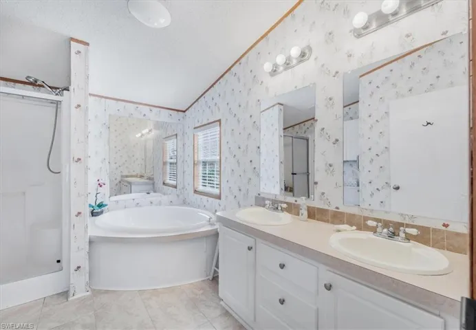 Luxurious Primary Bath Featuring Dual Sinks, Soaking Tub, and Walk-In Showe
