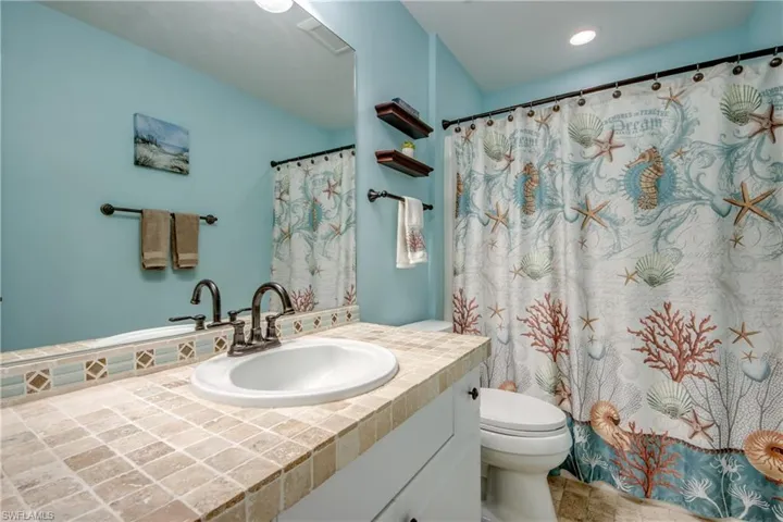 Full bath featuring vanity and curtained shower