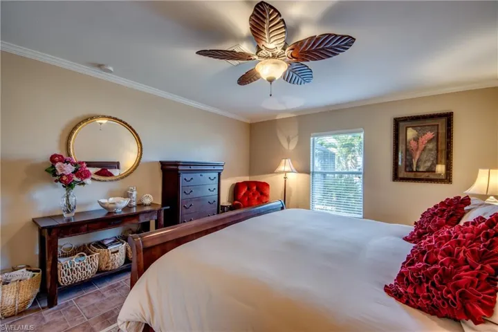 Bedroom featuring crown molding and a ceiling fan