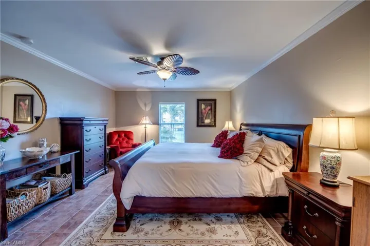 Bedroom featuring crown molding and ceiling fan