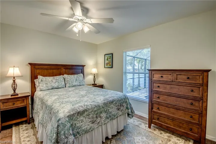 Bedroom featuring a ceiling fan and baseboards