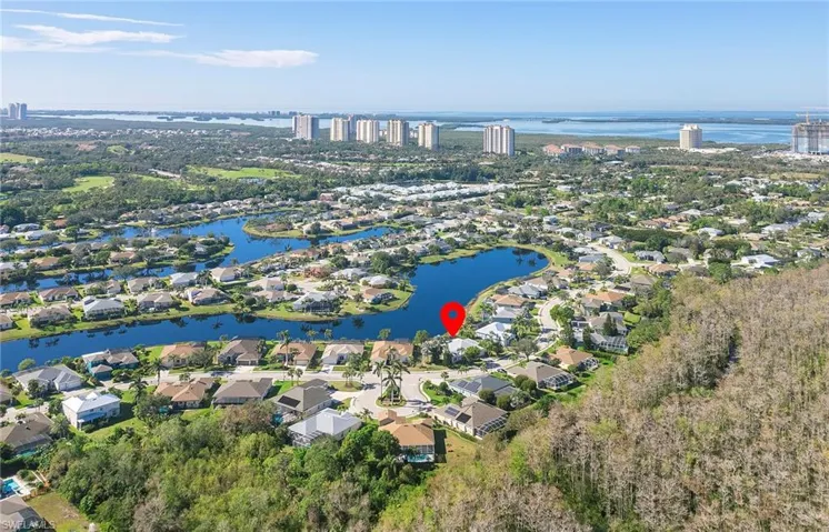 Aerial overview of property's location with a nearby body of water and nearby suburban area