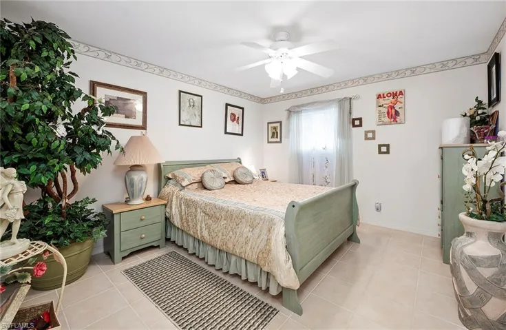 Bedroom featuring light tile patterned flooring and a ceiling fan